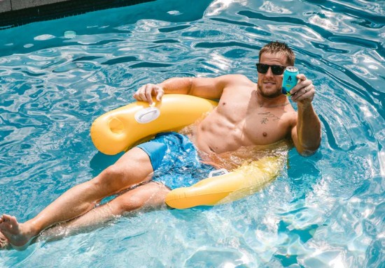 JJ Watt sips on an Athletic Run Wild in the pool