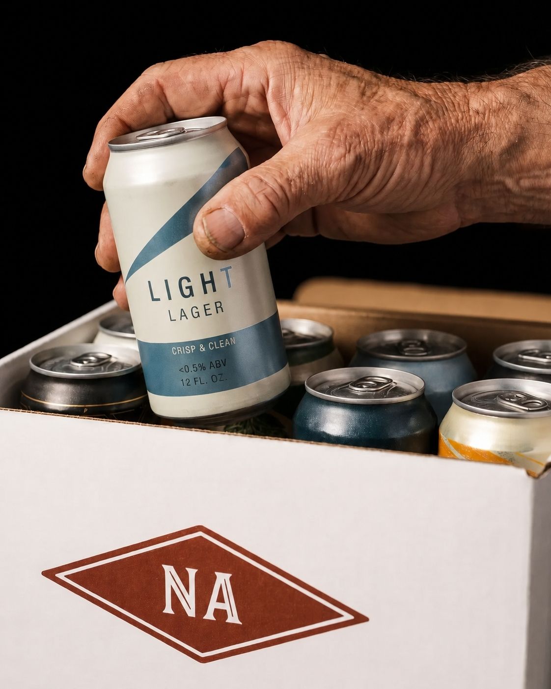 a hand pulling out a non alcoholic beer from the na beer club gift set subscription box